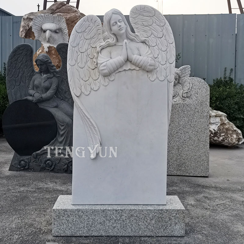 white marble praying angel gravestone